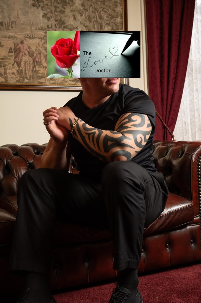 Man with elaborate arm tattoo on leather couch, rose and 