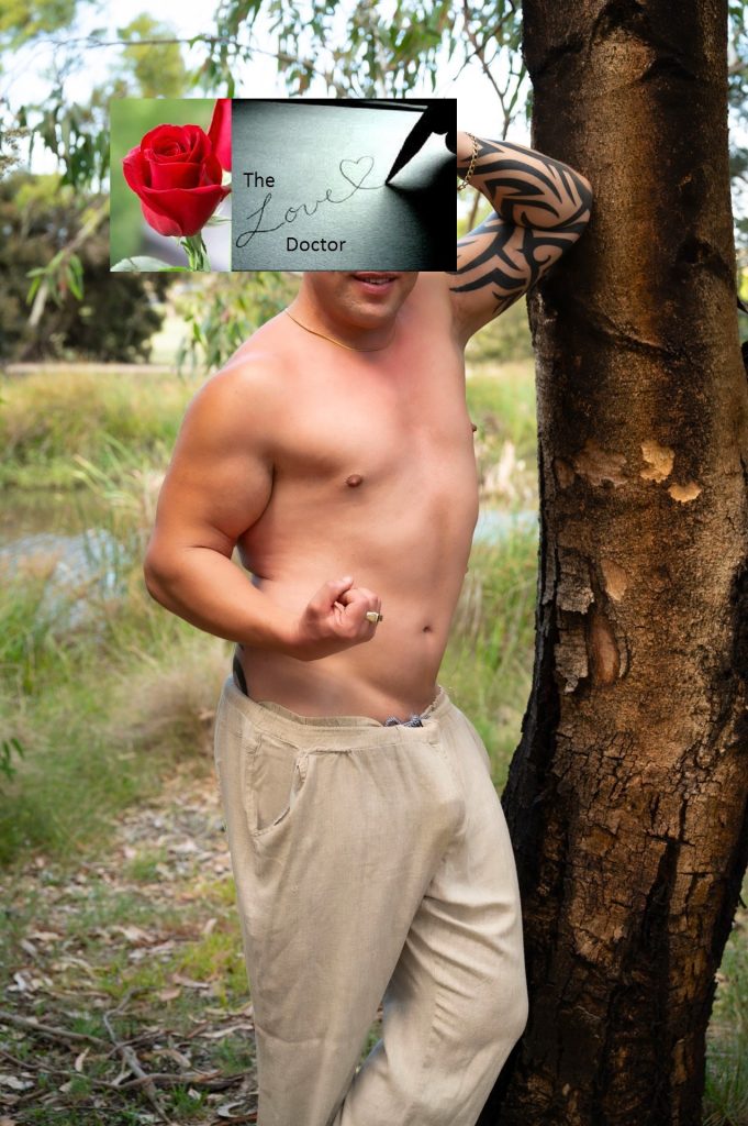 Man with tattooed arm leans on tree, 