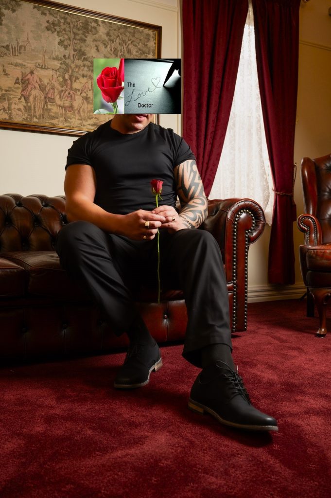 Man in black holding a red rose, with a blurred face and 