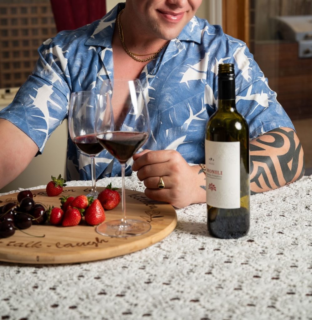 Man in a blue floral shirt with wine and fruit, February 2025 gallery