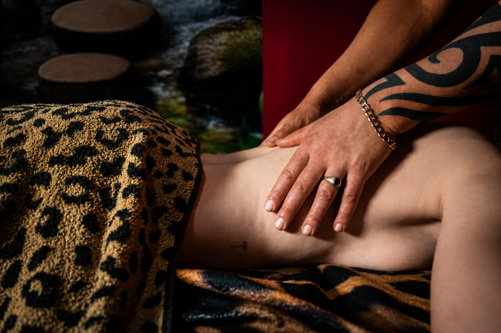 Close-up of a massage therapist's hands giving a back massage to a client.