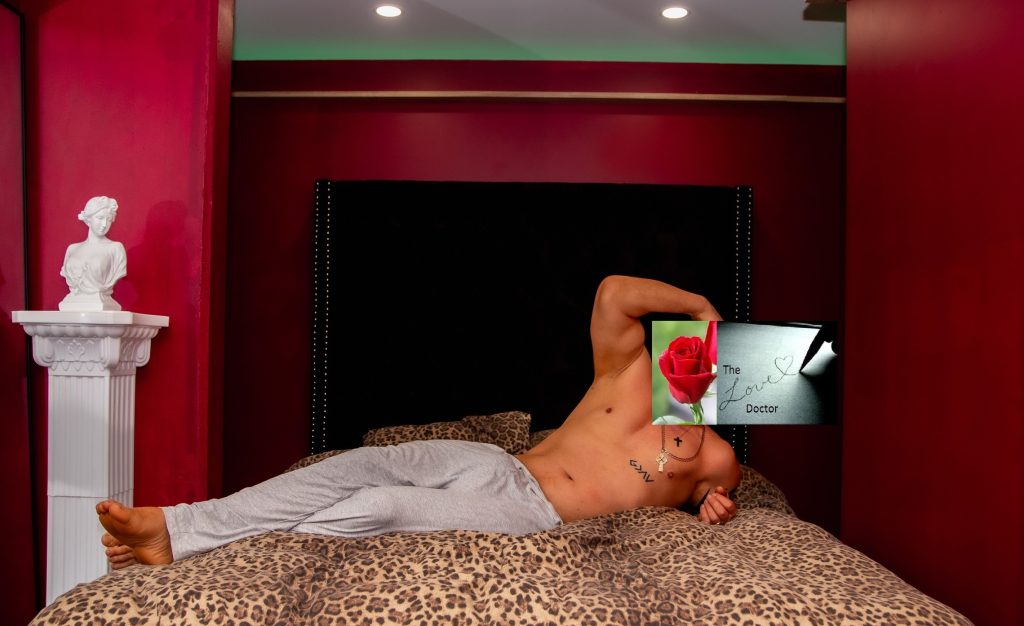 Man in bed holding a rose with 