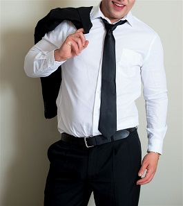Man in white dress shirt, black tie, and suit jacket over shoulder
